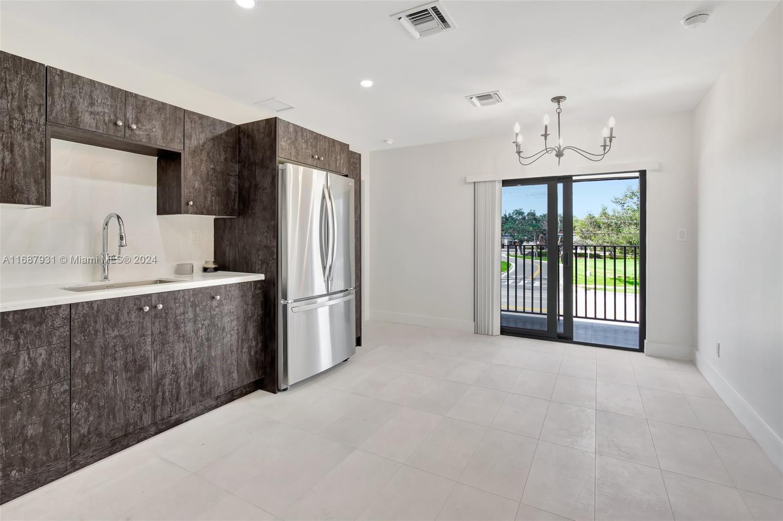 a kitchen with stainless steel appliances a refrigerator sink and cabinets