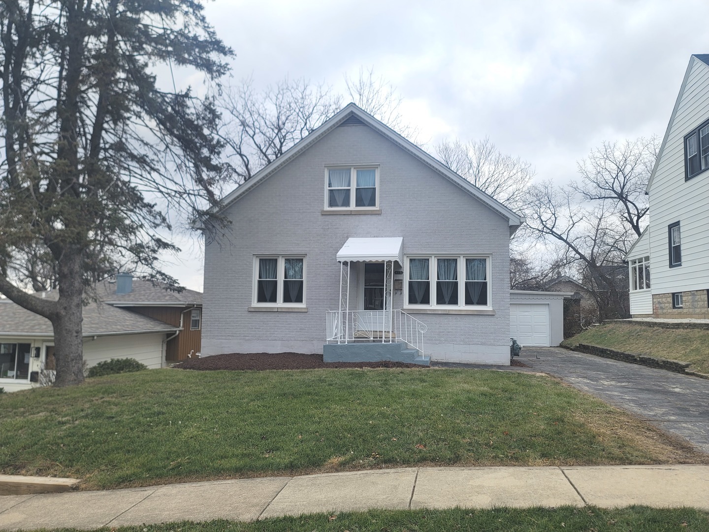 a front view of house with yard and green space