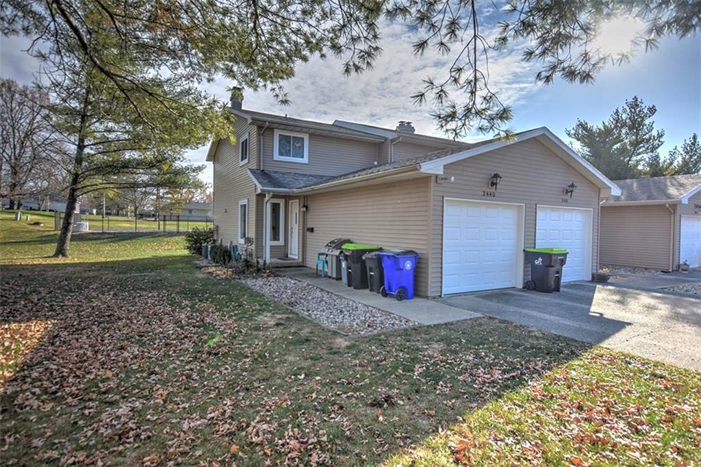 a view of a house with a yard and a tree