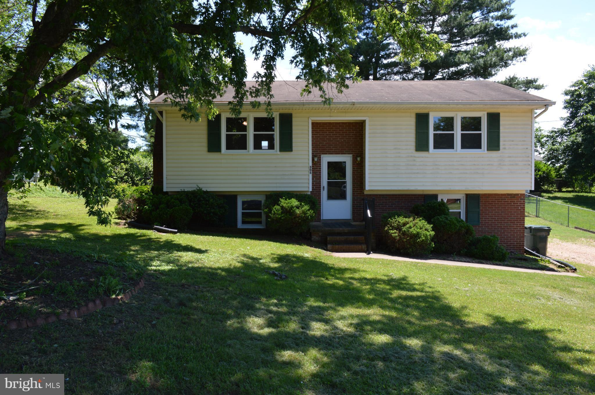 a view of a house with a yard and tree s