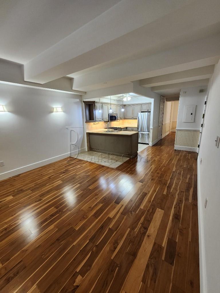 a view of water heater room with wooden floor