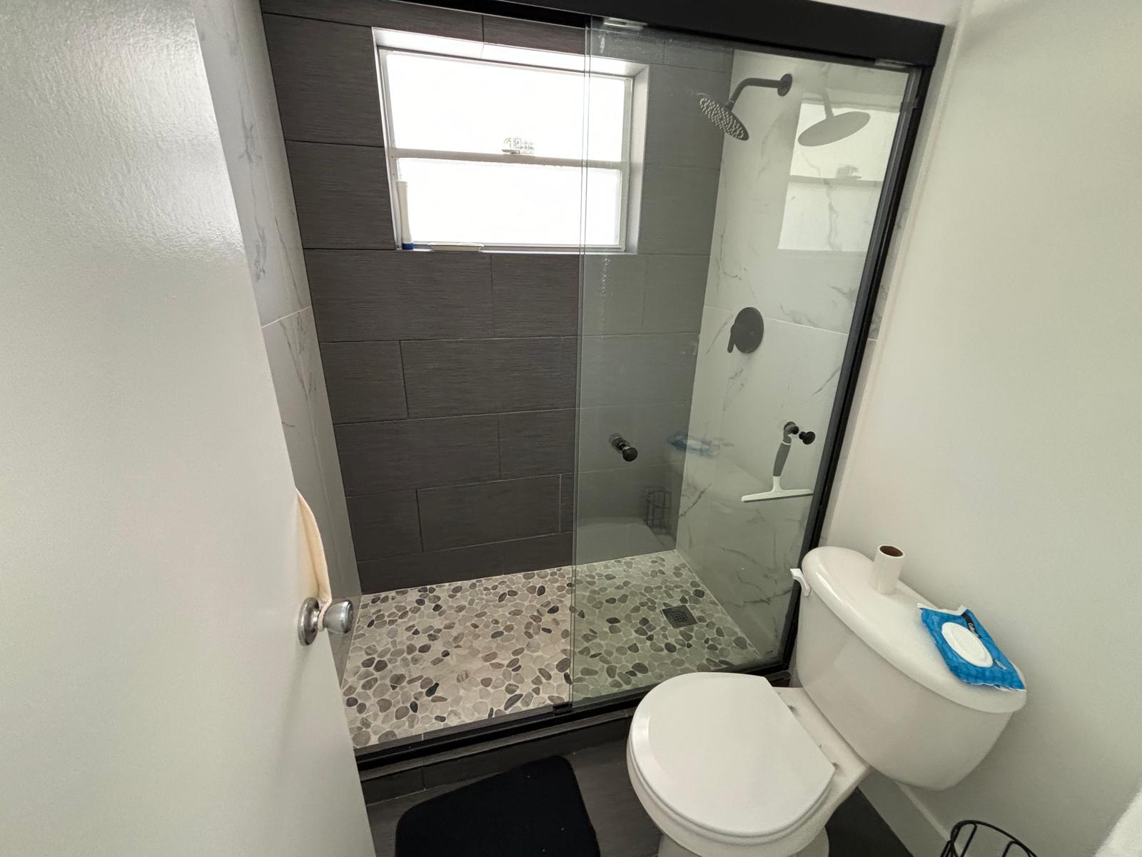 a bathroom with a granite countertop toilet sink and a mirror