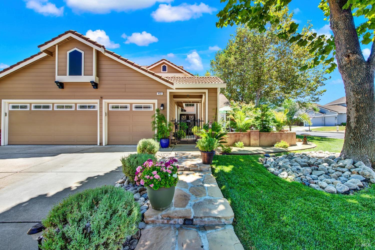 a front view of a house with a garden