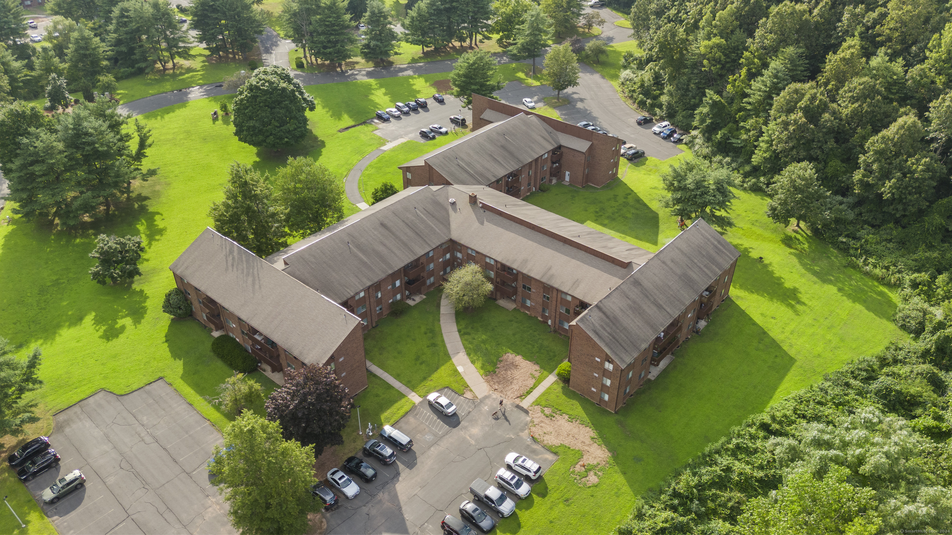 an aerial view of a house with a garden and swimming pool