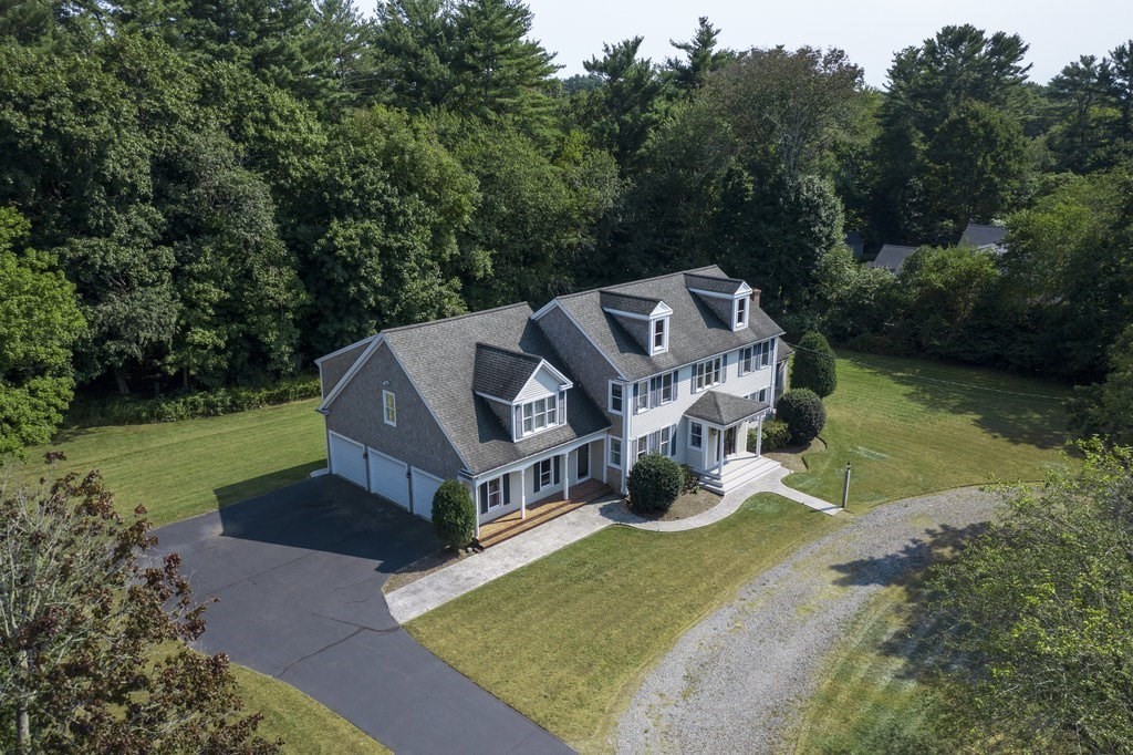 an aerial view of a house with swimming pool garden and patio