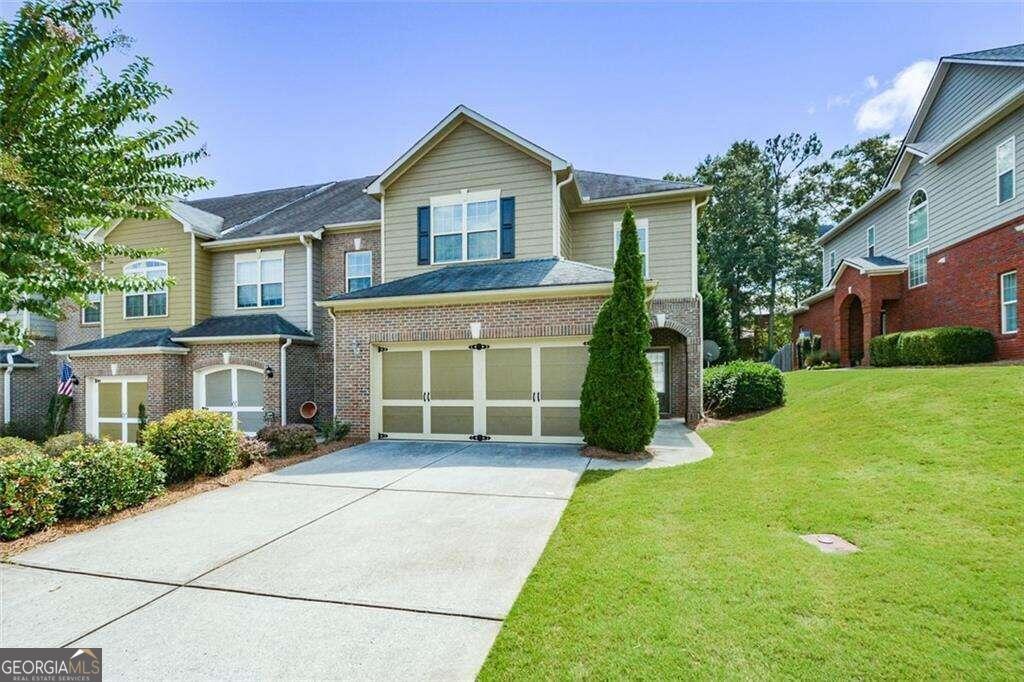 a front view of a house with garden