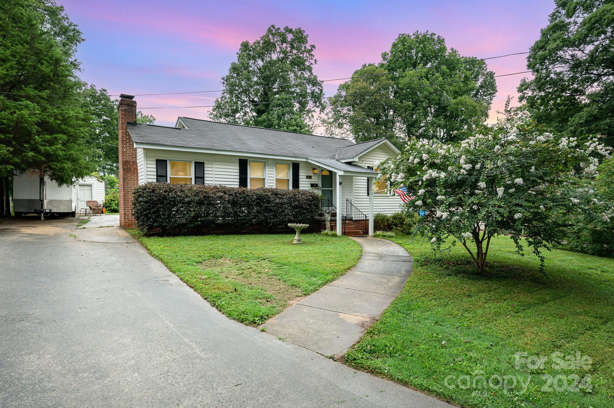 a front view of a house with a garden