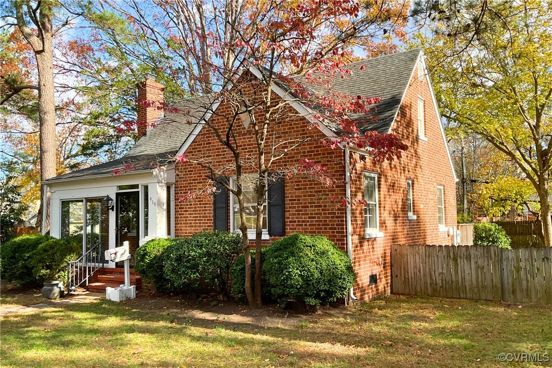 a front view of a house with a yard table and chairs