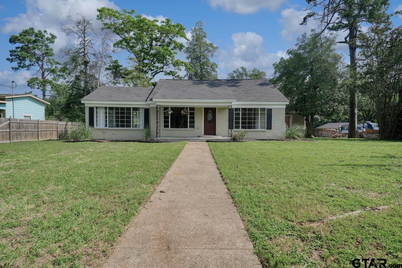 a front view of house with yard and green space