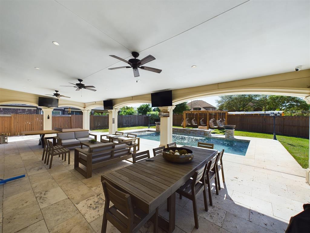 a view of a patio with a dining table and chairs