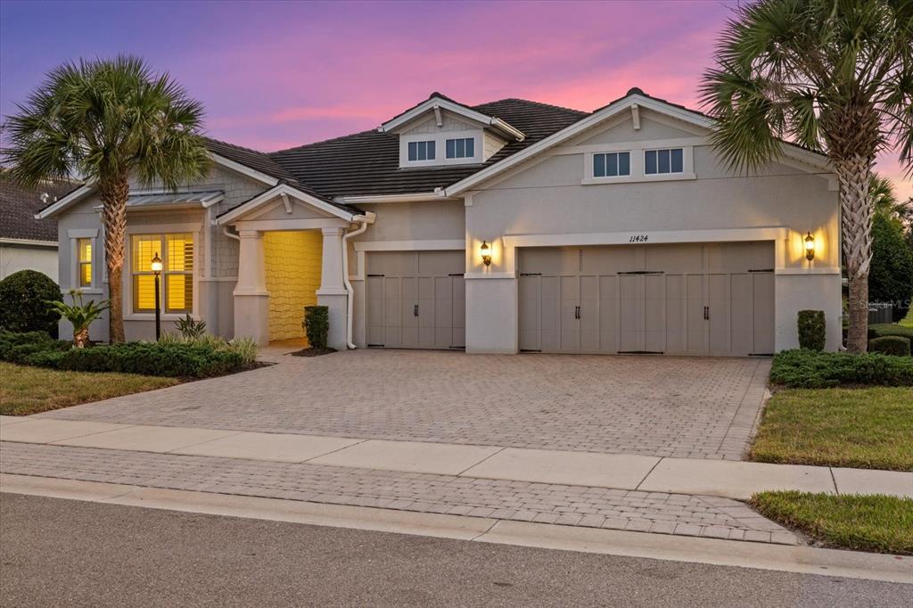 a front view of a house with a yard and garage