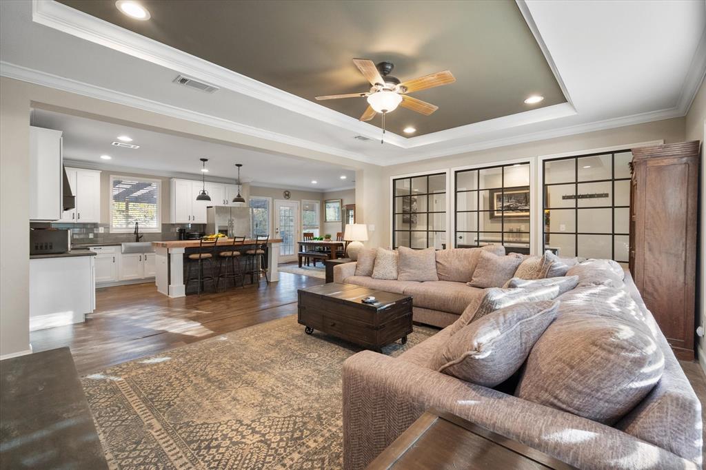 a living room with furniture and kitchen view