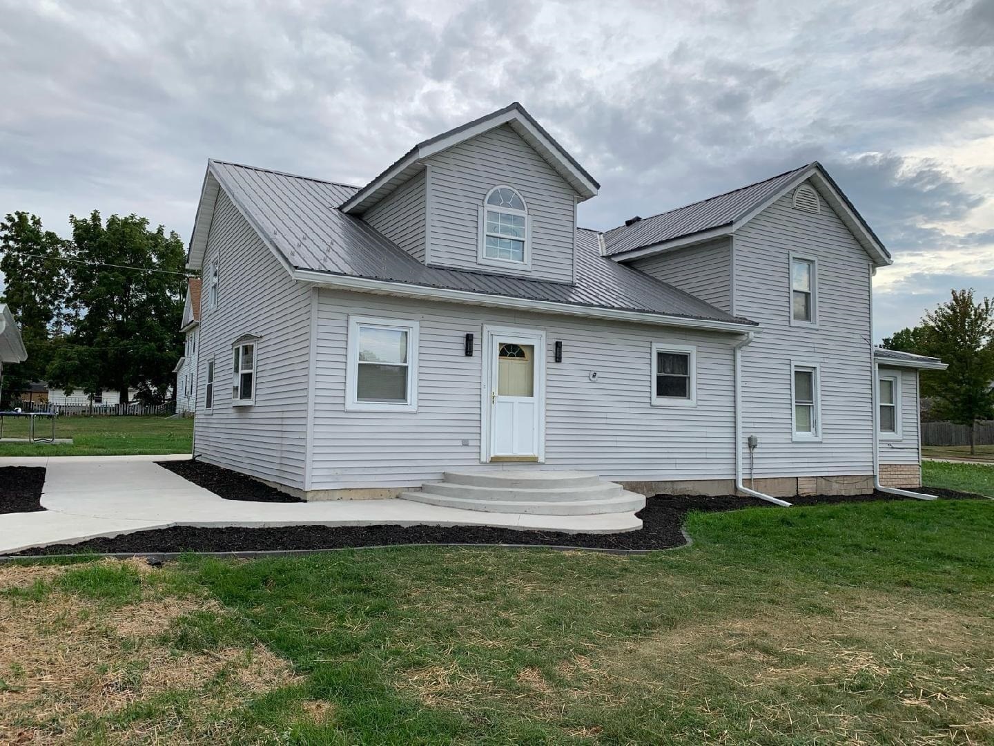 a front view of a house with a yard