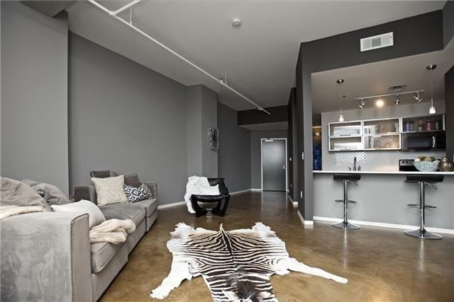 a bedroom with a bed and glass table