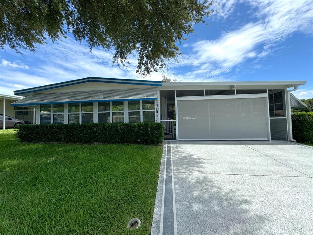 a view of house with backyard space and garden