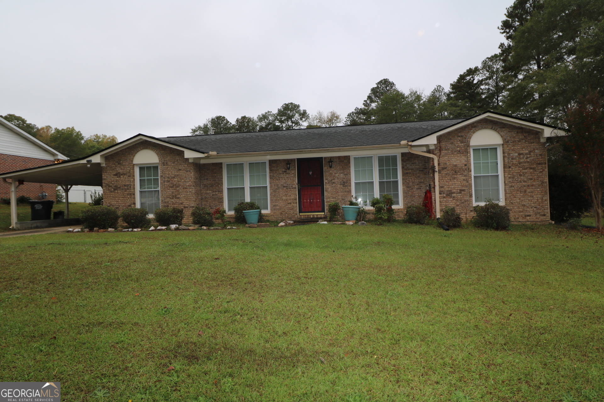 a front view of a house with a garden