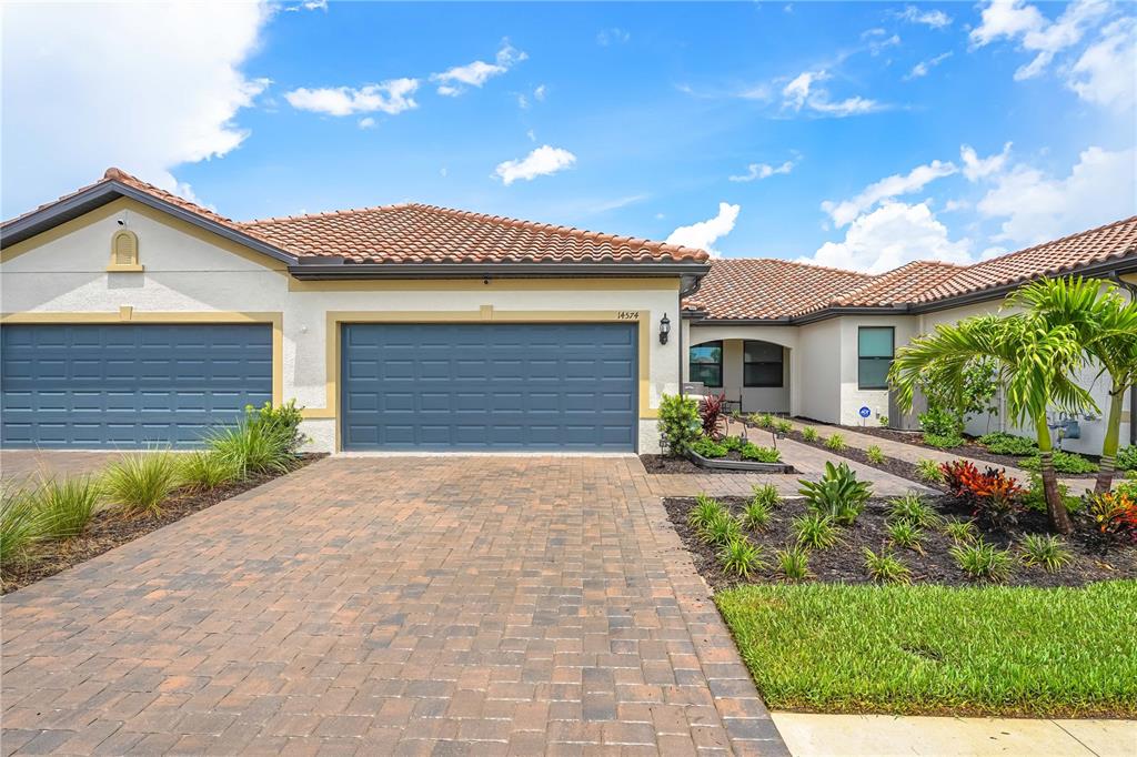 a front view of a house with a yard and garage