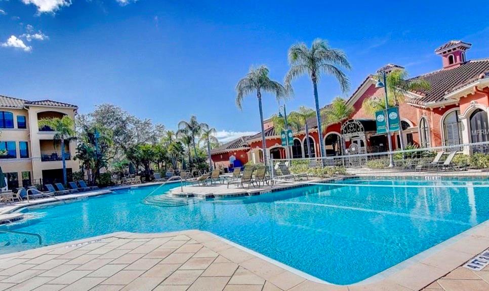 a house view with swimming pool and seating space