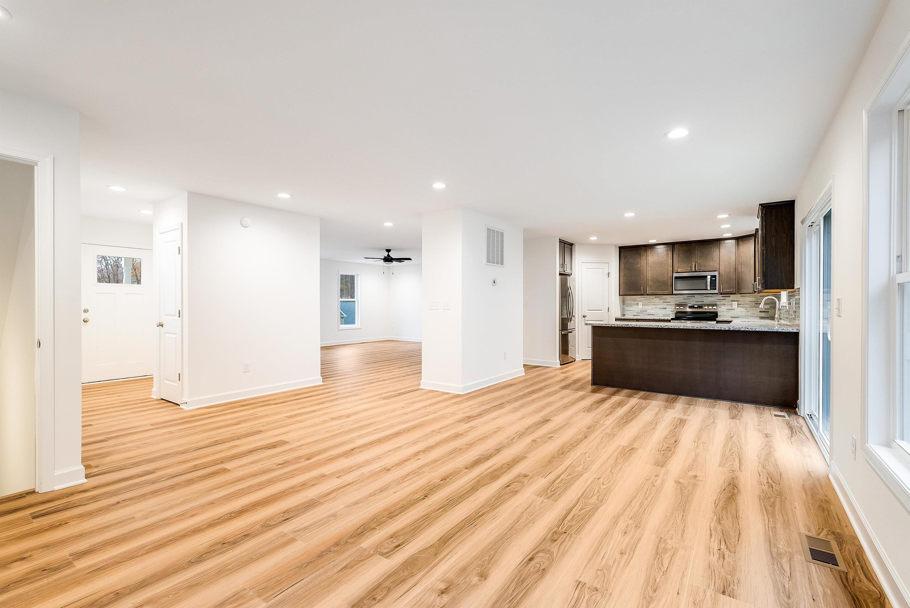 a view of kitchen with kitchen island refrigerator sink microwave and cabinets