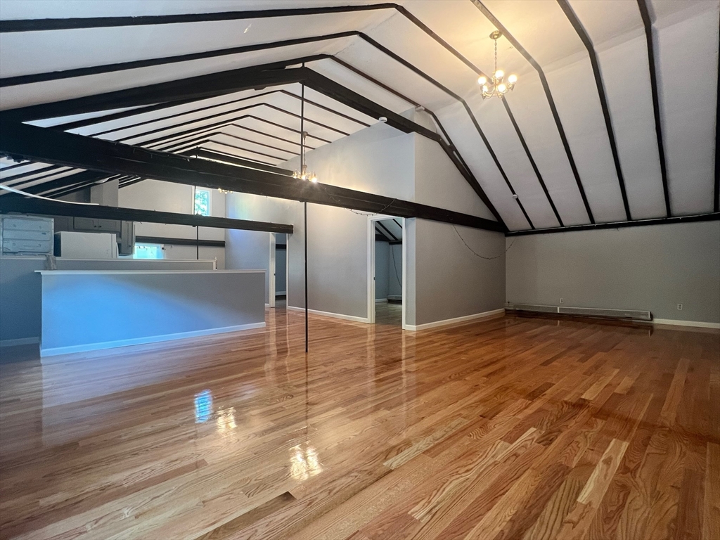 a view of a room with wooden floor