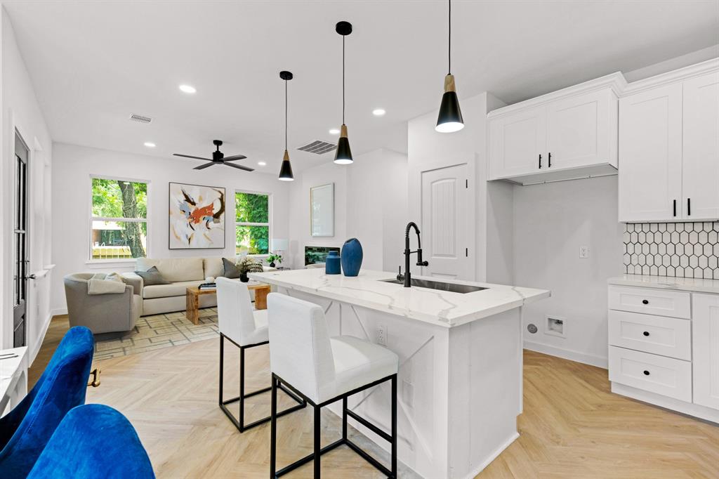 a living room with furniture and kitchen view