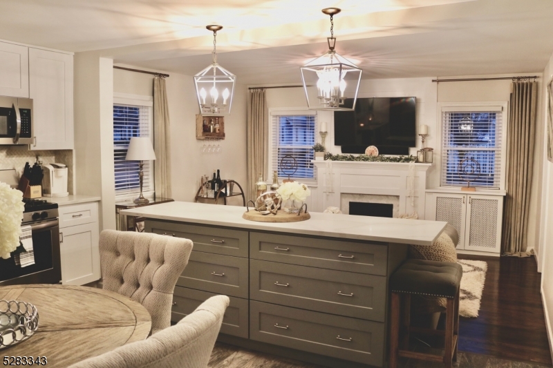 a living room with furniture a fireplace and kitchen view