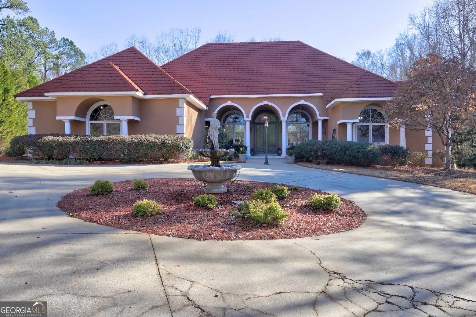 a front view of a house with garden