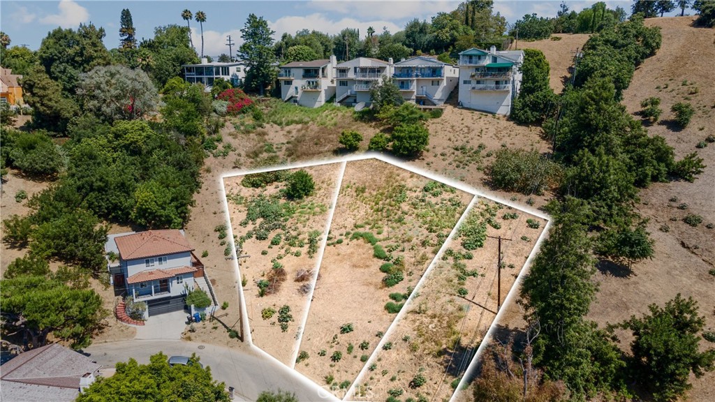 an aerial view of a house with a yard basket ball court and outdoor seating