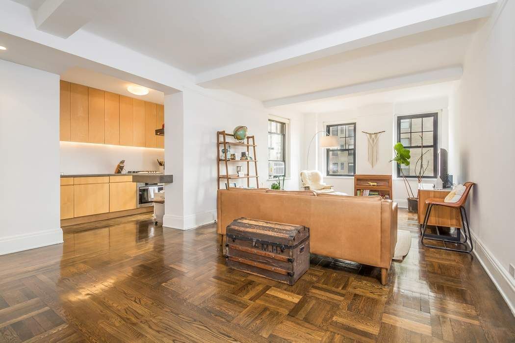 a bedroom with a bed and large windows