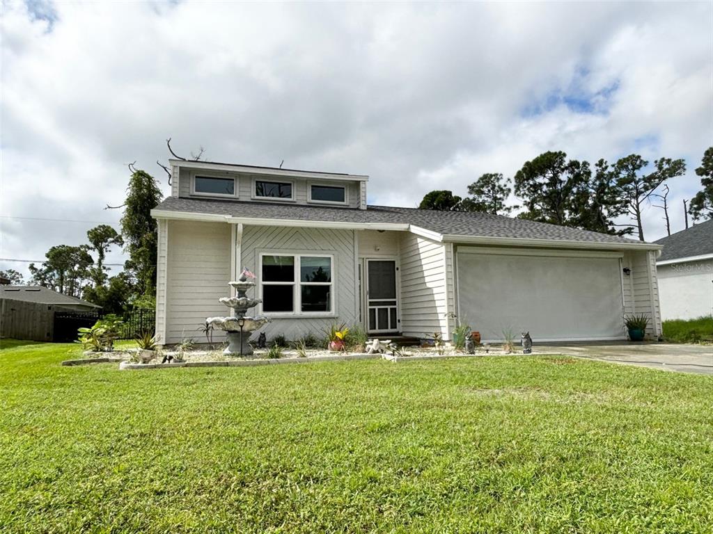 a front view of house with yard and seating area