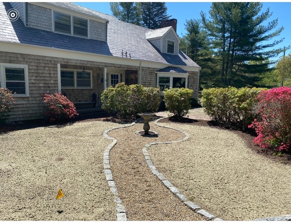 a view of a house with a yard and garden