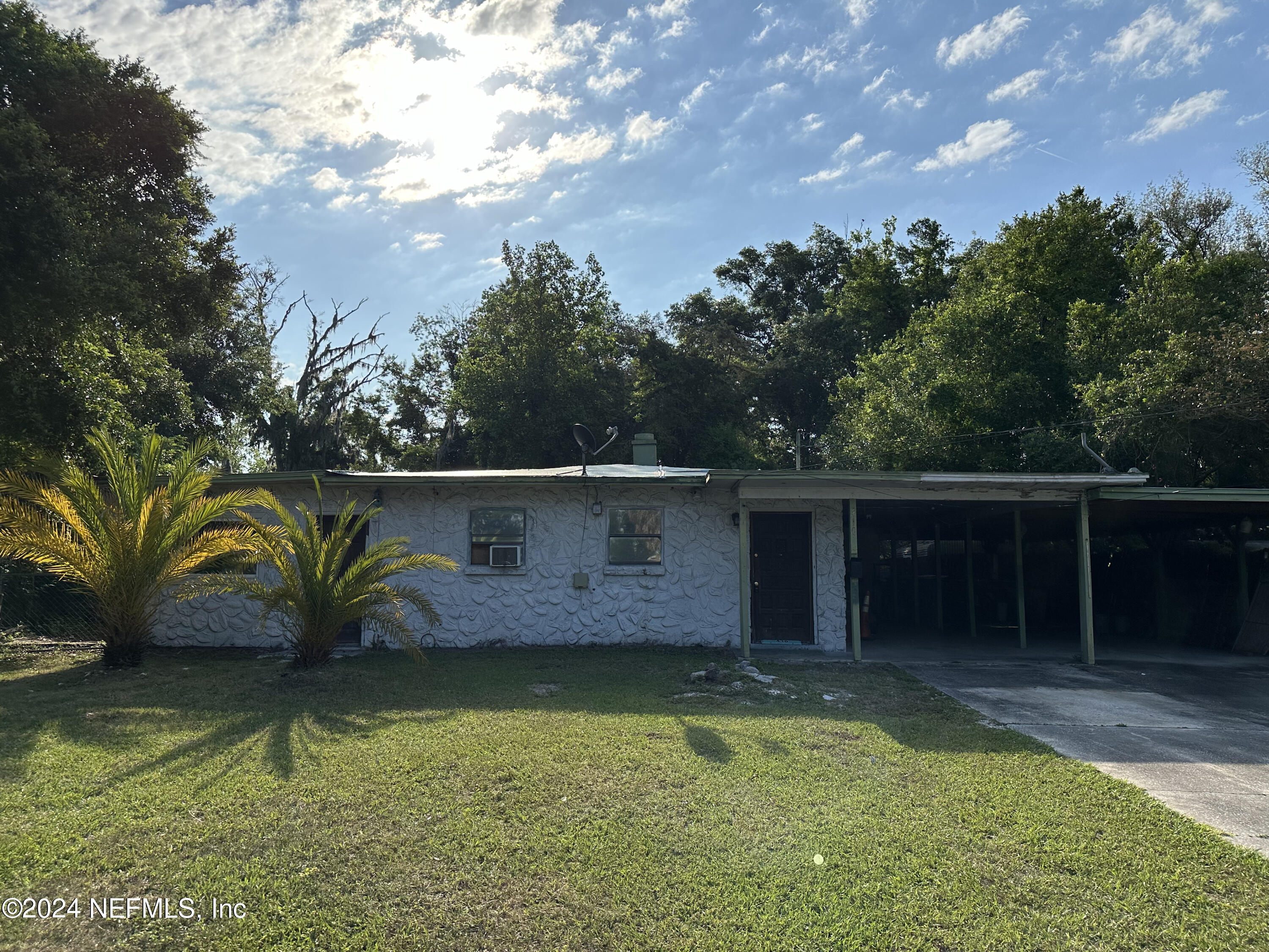 a view of house with pool and yard