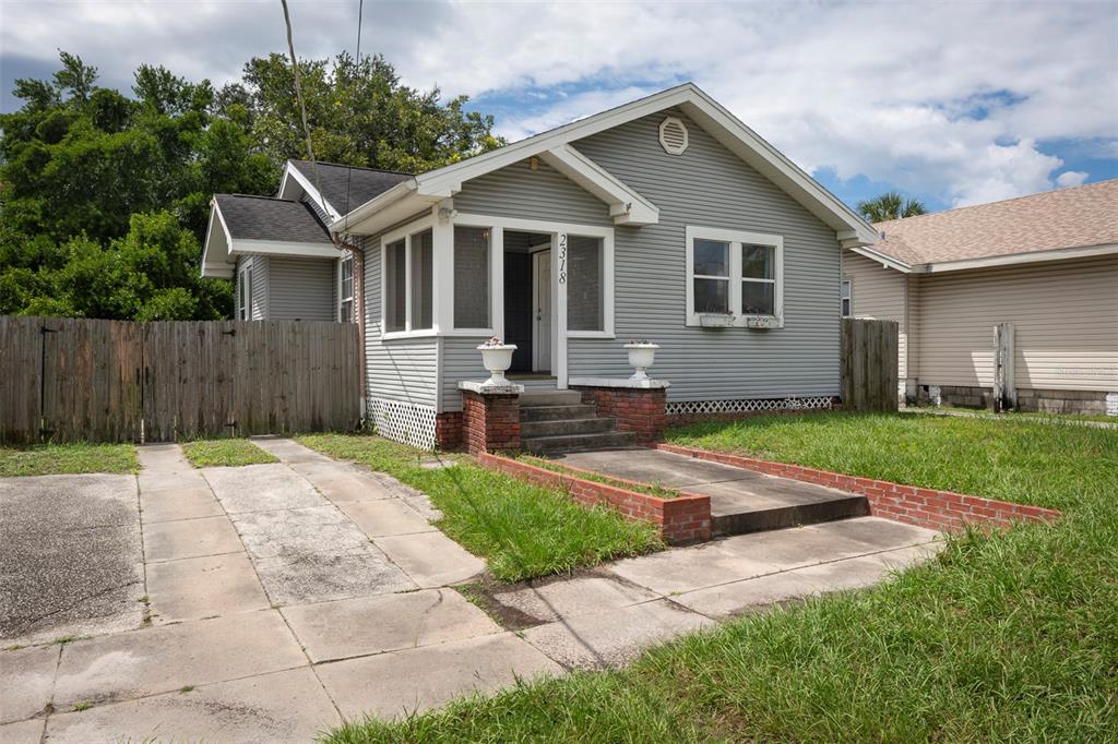 a front view of a house with a garden and yard