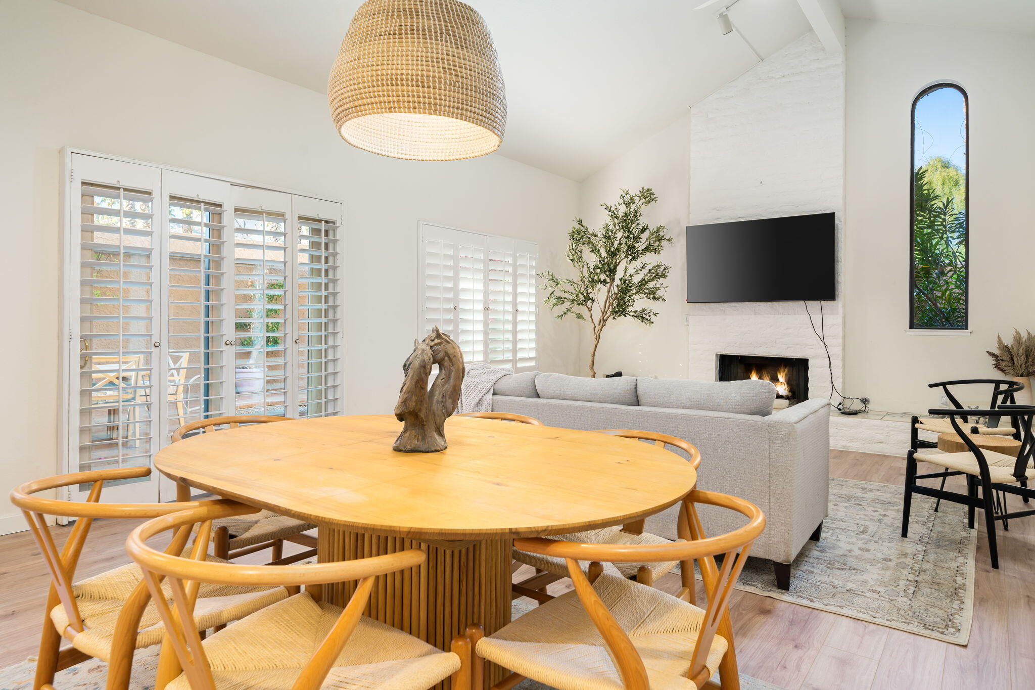 a view of a dining room with furniture and a flat screen tv