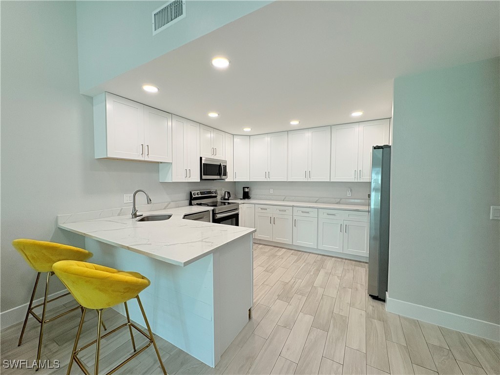 a kitchen with a sink a counter top space and cabinets