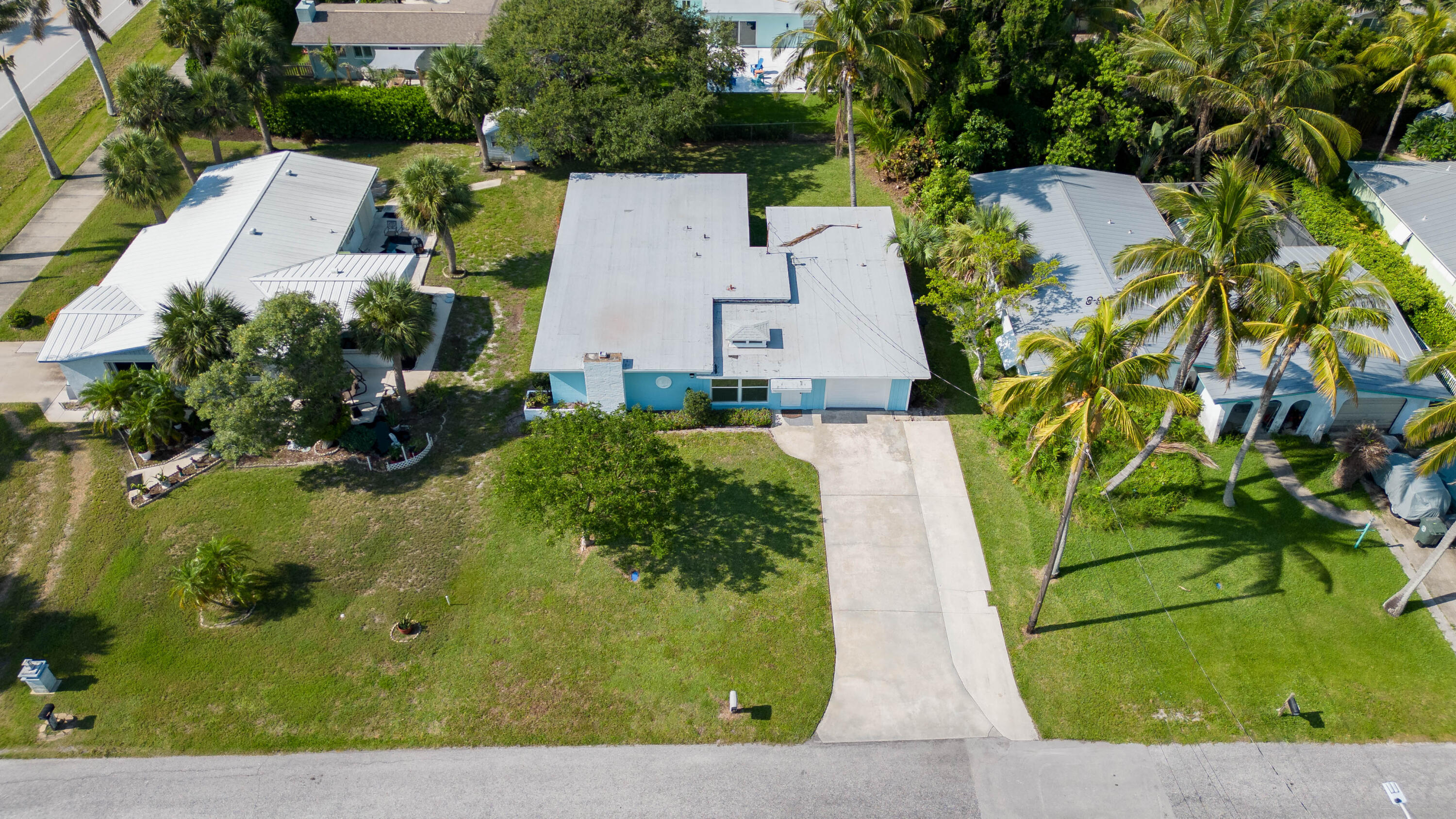 an aerial view of a house with a yard and trees