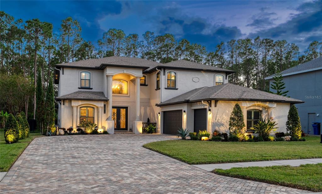 a front view of a house with a garden