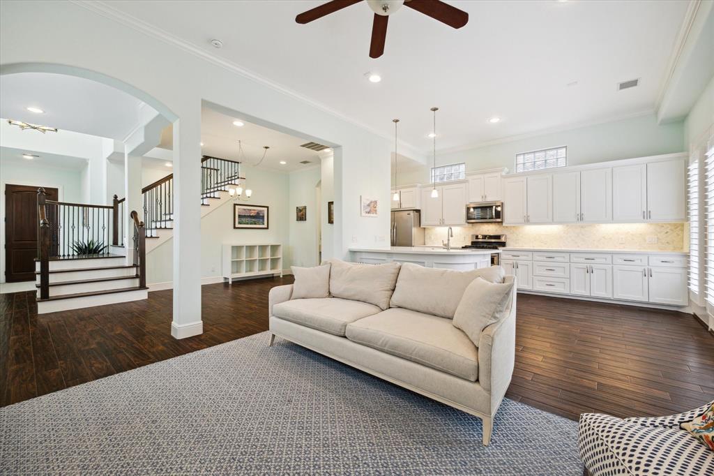 a living room with stainless steel appliances kitchen island granite countertop furniture and a kitchen view