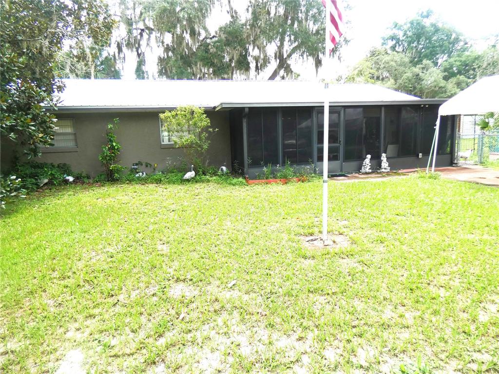 a view of a house with a yard and tree