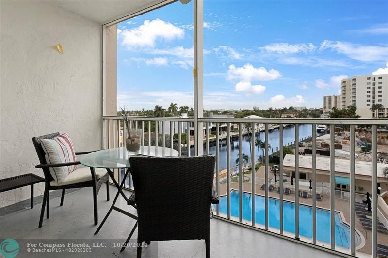 a view of a chairs and table on the balcony