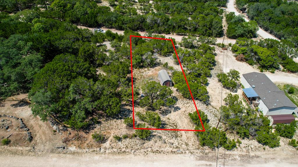 an aerial view of a houses with a yard