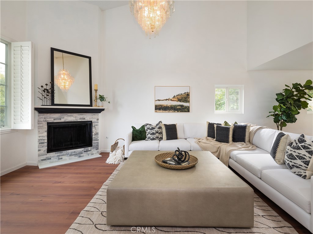 a living room with furniture a fireplace and a large mirror