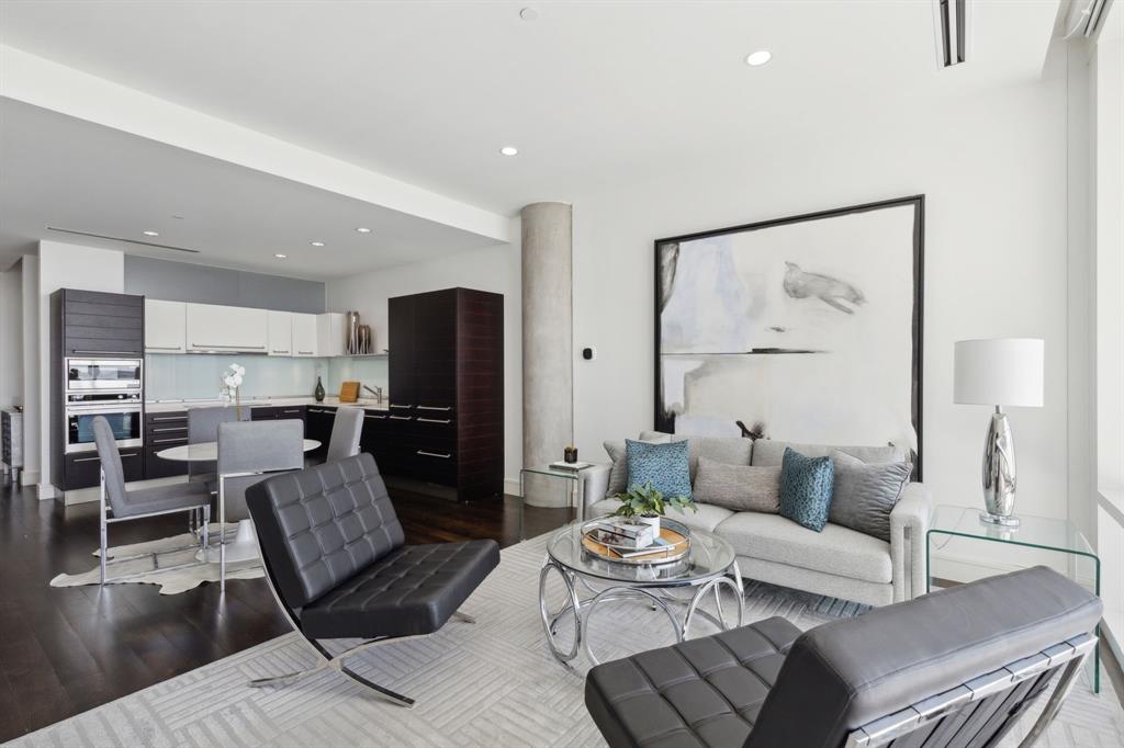 a living room with furniture and a view of kitchen