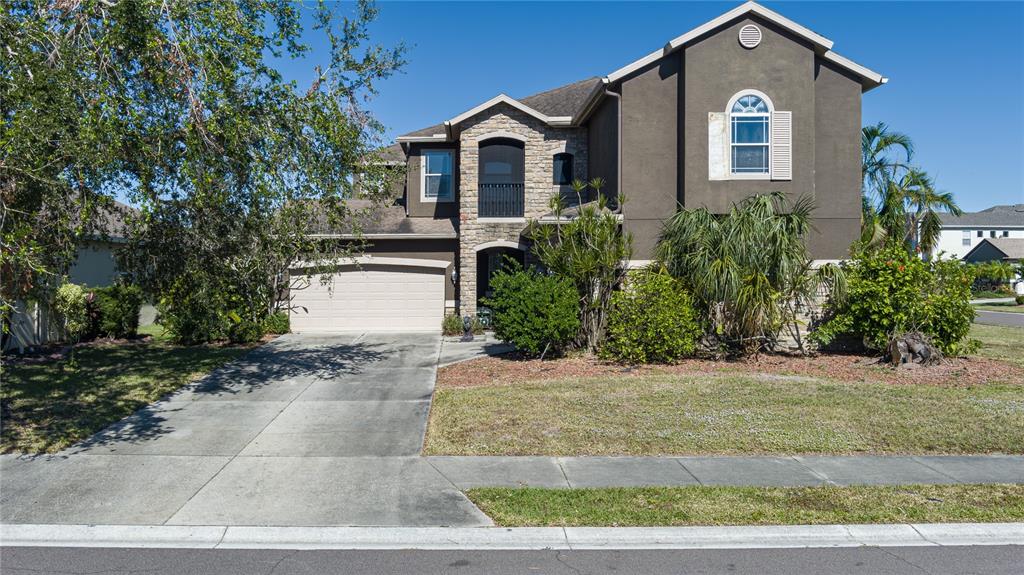 a front view of a house with a yard and garage