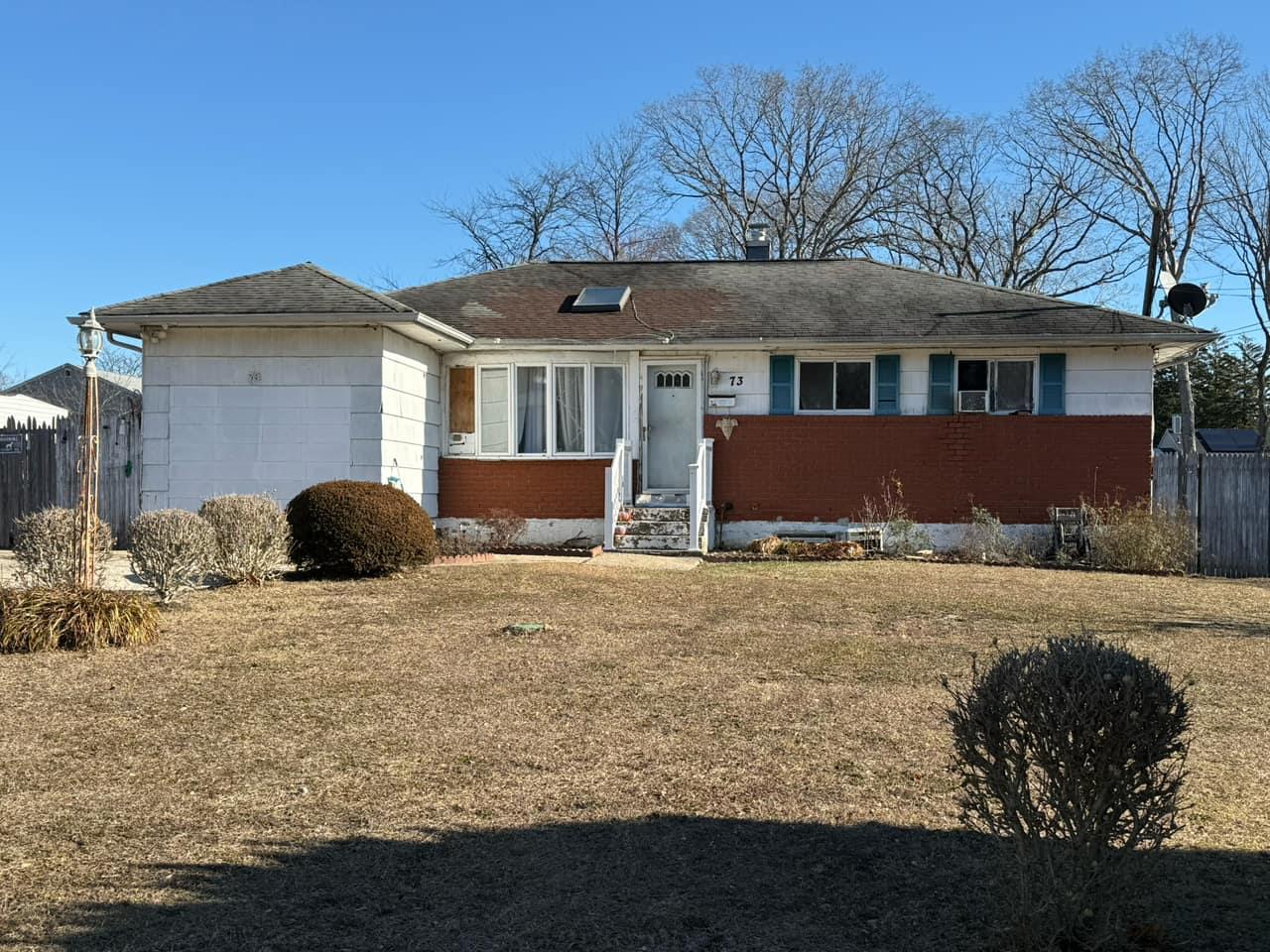 Single story home featuring a front lawn