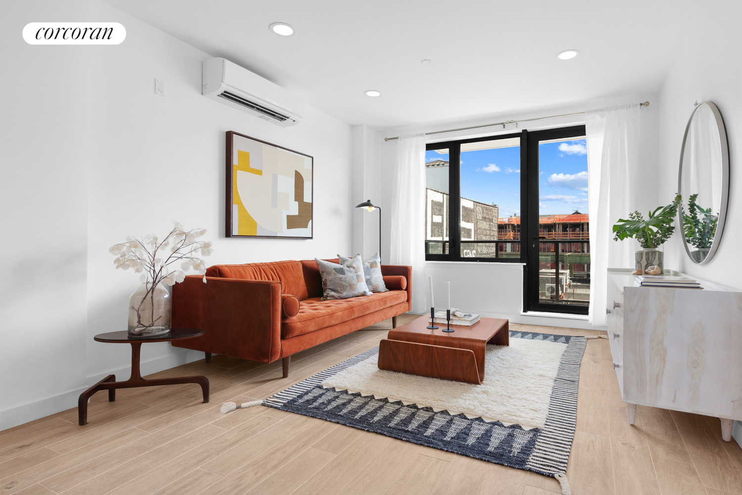 a living room with furniture and wooden floor