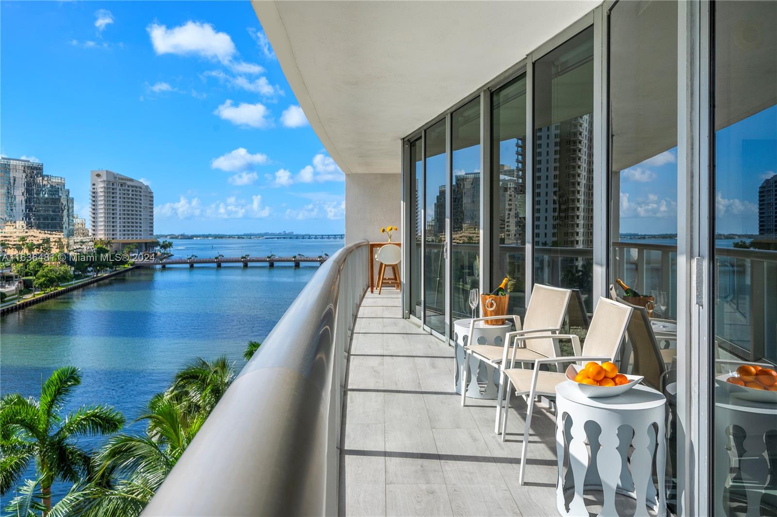 a balcony with furniture and water view