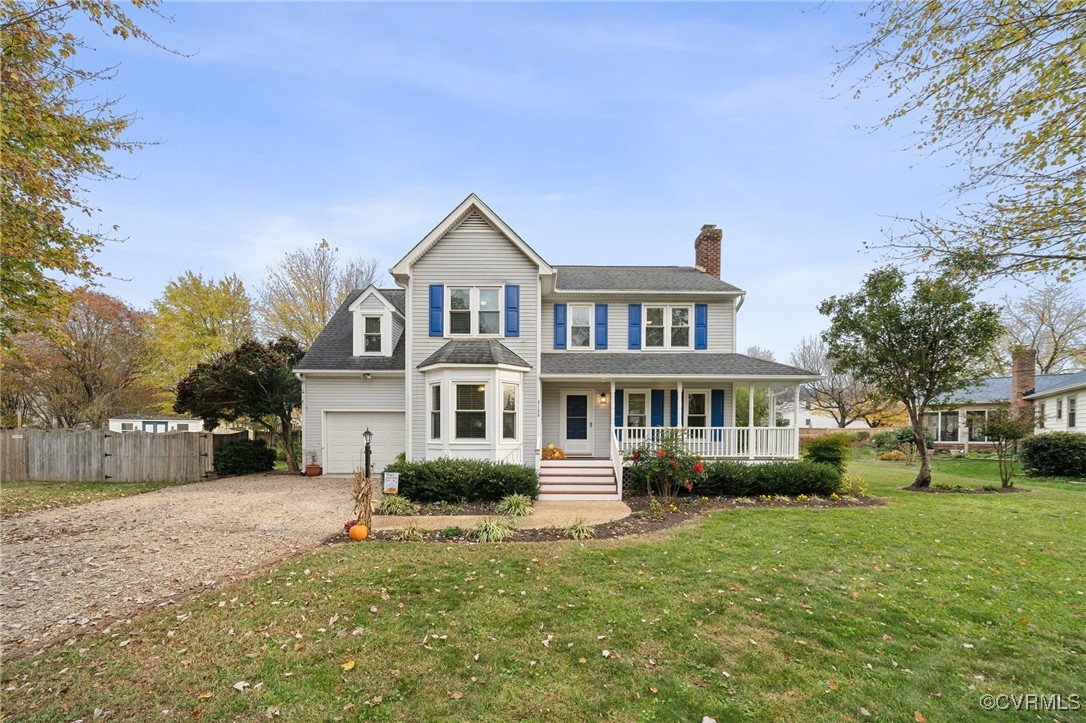 View of front of house with a garage, covered porc