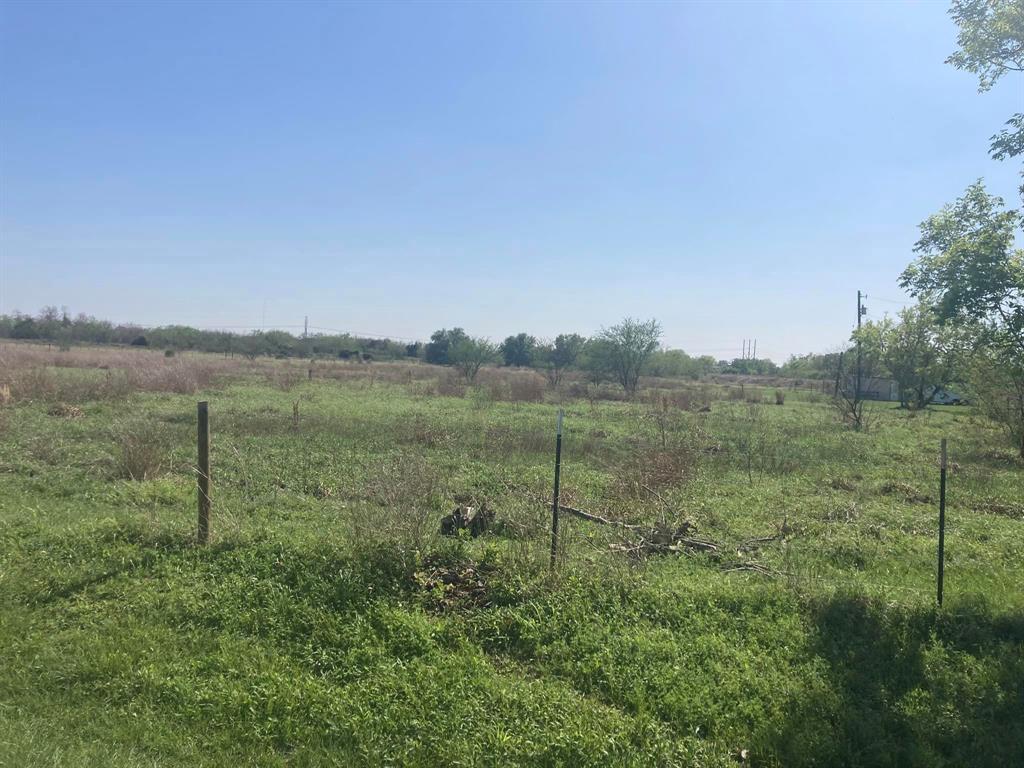 a view of a field with an ocean view