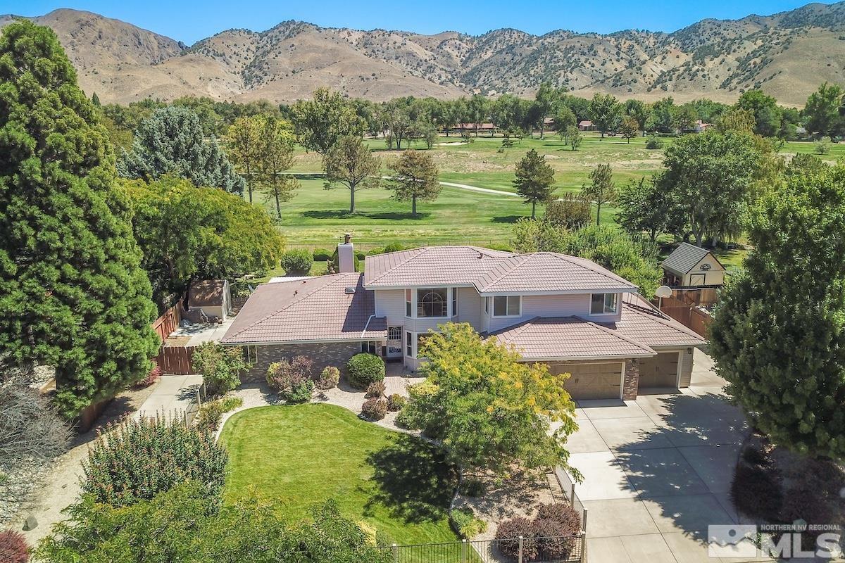 an aerial view of a house with a mountain in the background